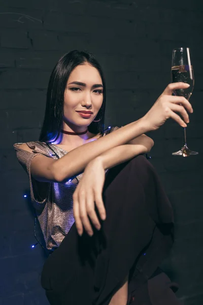Asian woman with glass of champagne — Stock Photo