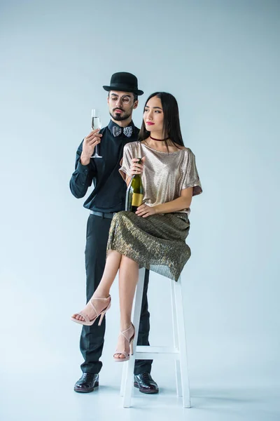Fashionable multicultural couple with champagne — Stock Photo