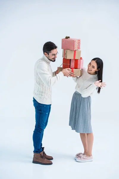 Multicultural couple holding christmas gifts — Stock Photo