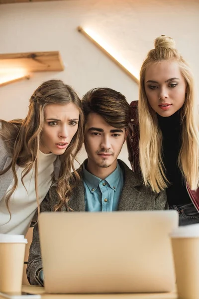 People looking at laptop with surprise — Stock Photo