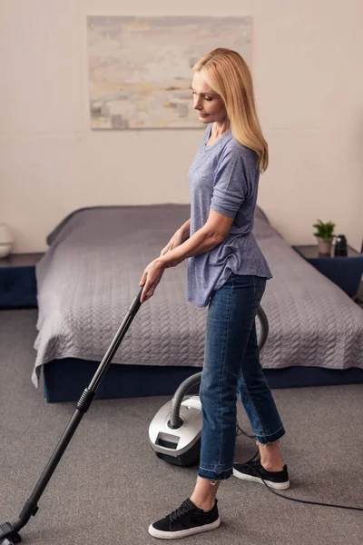 Woman with vacuum cleaner at home — Stock Photo