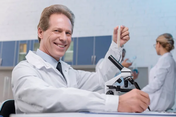 Chemist holding test tube — Stock Photo