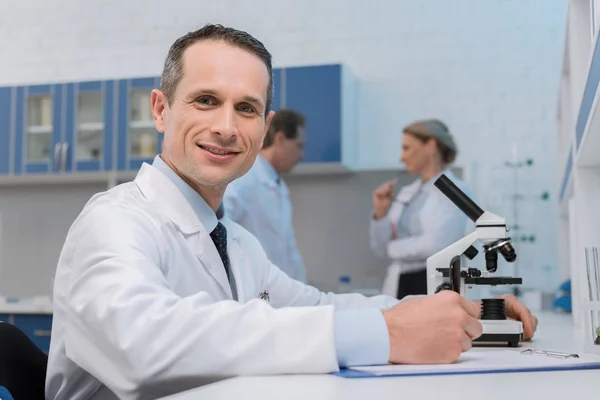 Lab technician taking notes — Stock Photo