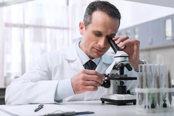 Scientist working with microscope — Stock Photo