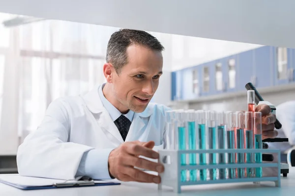 Scientist working with test tubes — Stock Photo