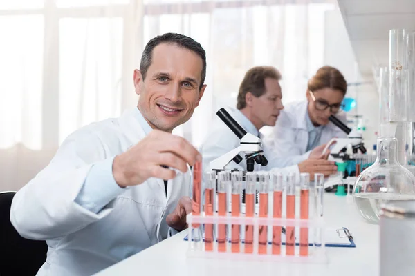 Scientist holding test tube — Stock Photo