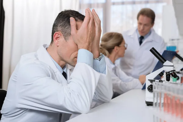 Tired scientist at laboratory — Stock Photo