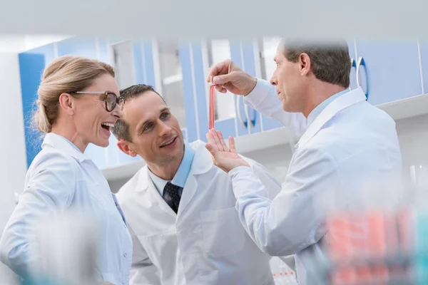 Scientists examining test tube — Stock Photo