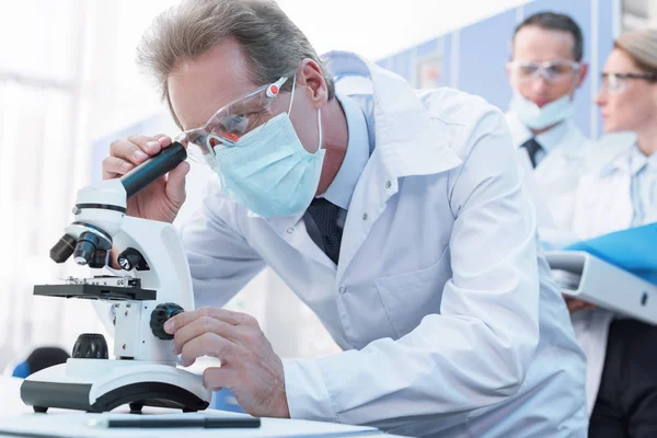 Scientist working with microscope — Stock Photo