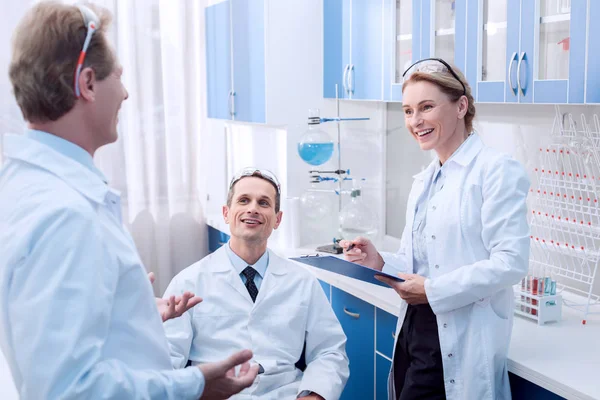 Smiling scientists talking — Stock Photo