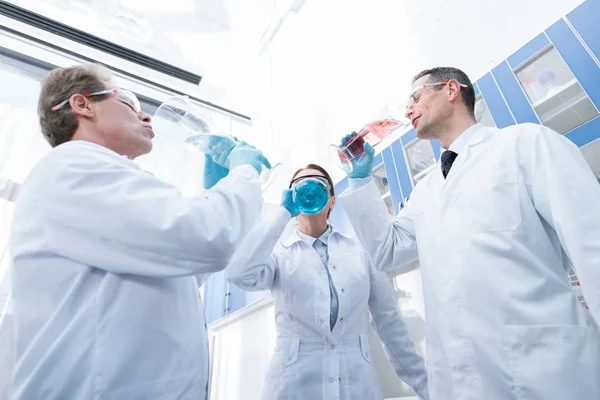 Doctors pretending to drink from test tubes — Stock Photo