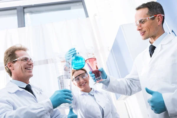 Doctors clinking test tubes — Stock Photo