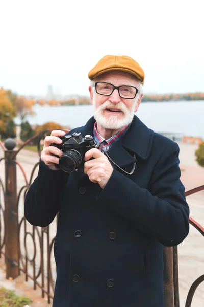 Senior man with photo camera — Stock Photo