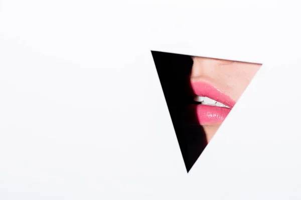 Pink lips behind triangle hole — Stock Photo