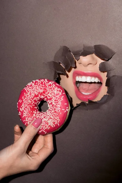 Woman trying to bite donut — Stock Photo
