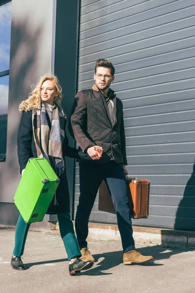 Young couple with suitcases — Stock Photo