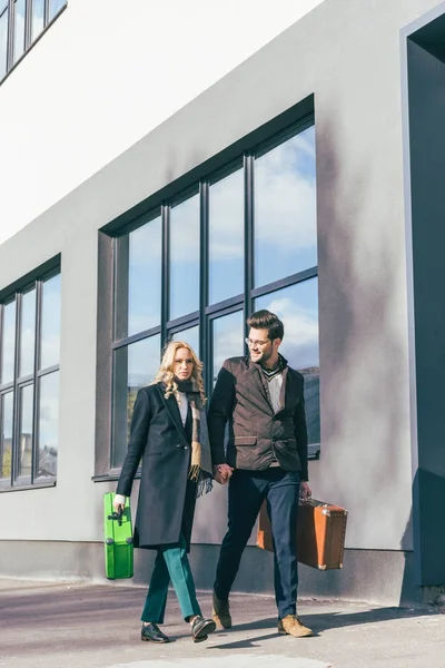 Young couple with suitcases — Stock Photo