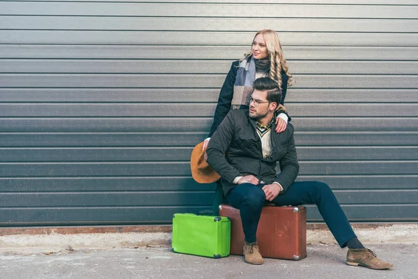 Young couple with suitcases — Stock Photo