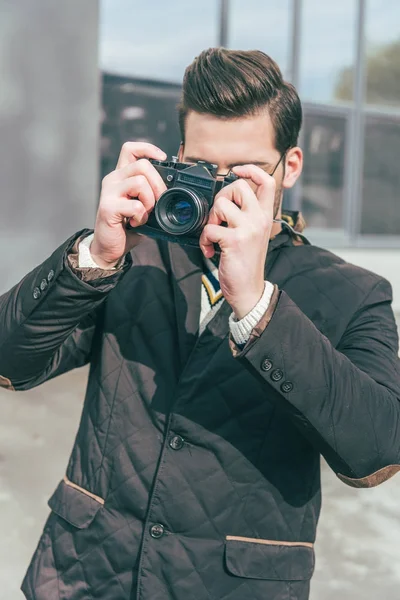 Young man with camera — Stock Photo