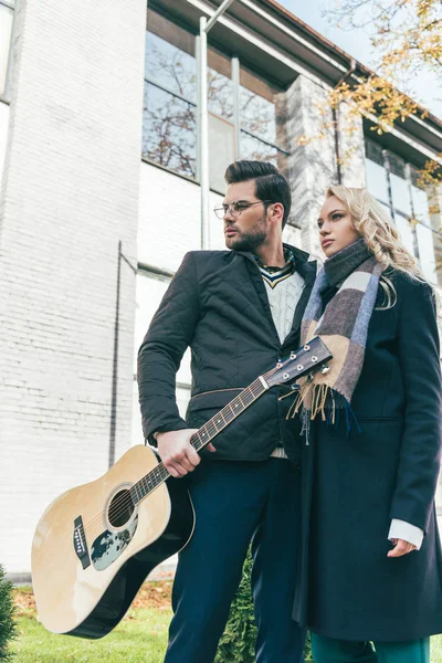 Casal em roupa de outono com guitarra — Fotografia de Stock