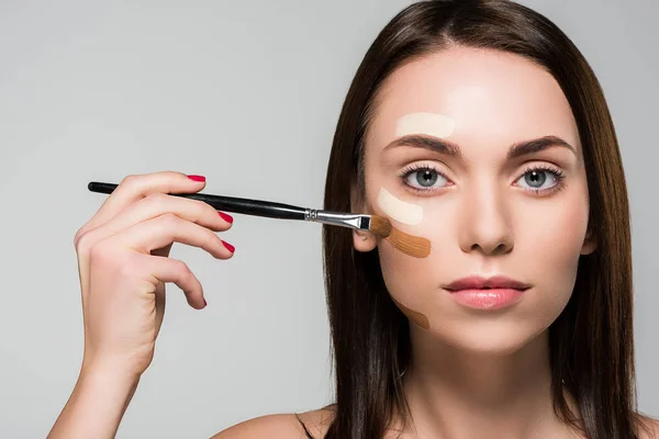 Woman with tonal foundation on face — Stock Photo