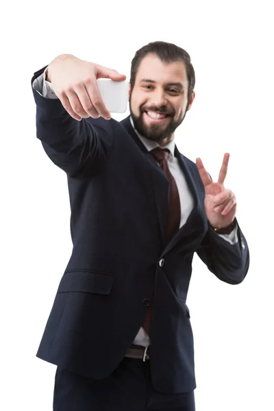 Businessman taking selfie on smartphone — Stock Photo