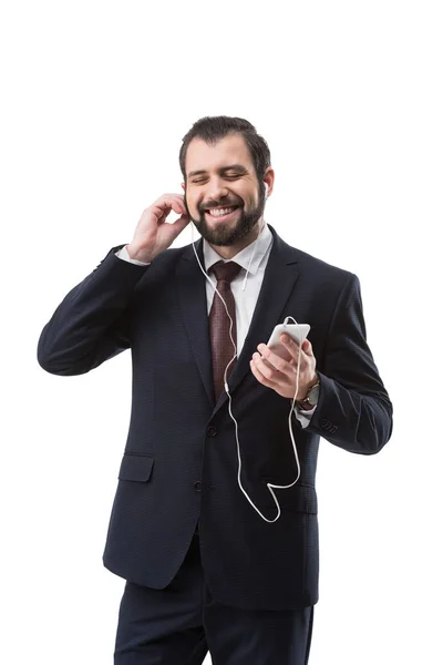 Businessman listening music with earphones — Stock Photo