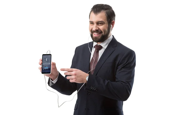 Businessman pointing at smartphone — Stock Photo