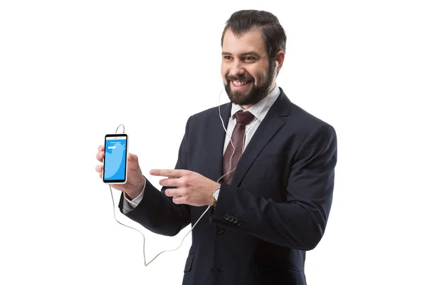 Businessman pointing at smartphone — Stock Photo