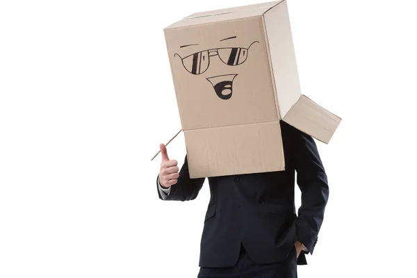 Business man with thumb up and box on head — стоковое фото