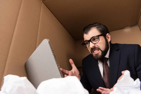 Aggressive businessman with cardboard laptop — Stock Photo