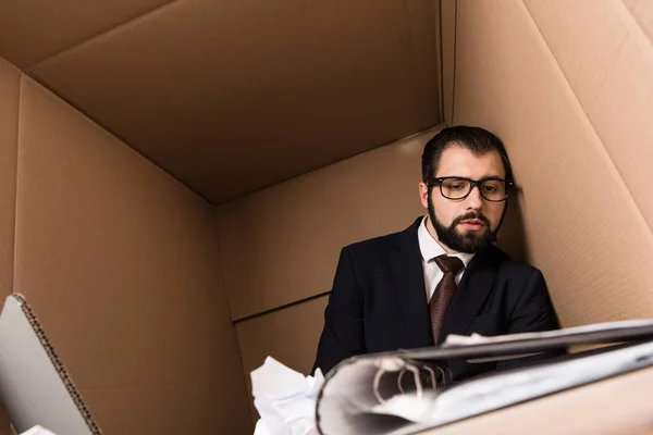 Exhausted businessman with paperwork — Stock Photo