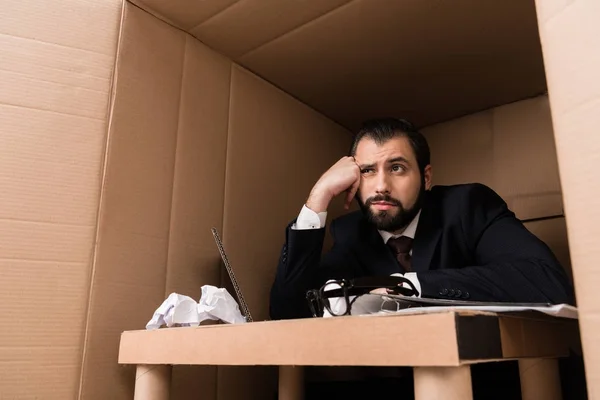 Bored businessman in box — Stock Photo