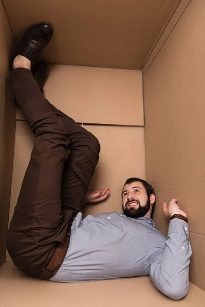 Depressed man in cardboard box — Stock Photo