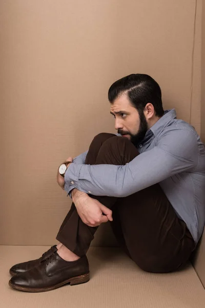 Depressed man in box — Stock Photo