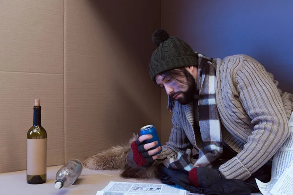 Homeless man with alcohol drinks — Stock Photo