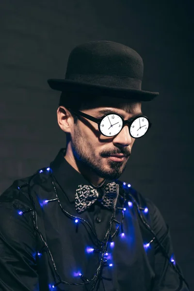 Fashionable man with christmas lights — Stock Photo
