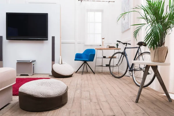 Interior of living room with TV and bicycle — Stock Photo