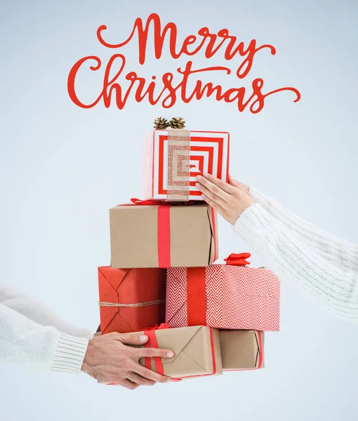 Couple holding christmas gifts — Stock Photo