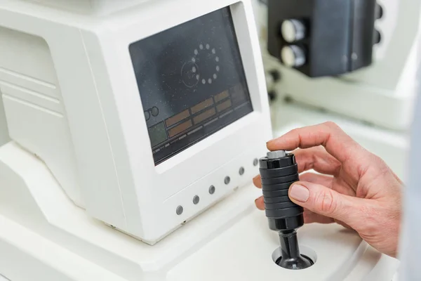 Cropped view of optometrist working with slit lamp in clinic — Stock Photo