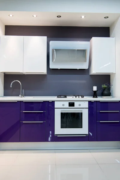 Purple modern kitchen interior with baking oven — Stock Photo