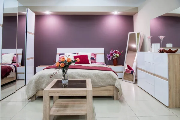 Cozy modern bedroom interior in purple tones — Stock Photo