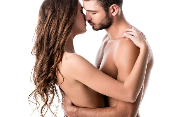 Vista lateral de sensual pareja semidesnuda besándose aislada en blanco - foto de stock