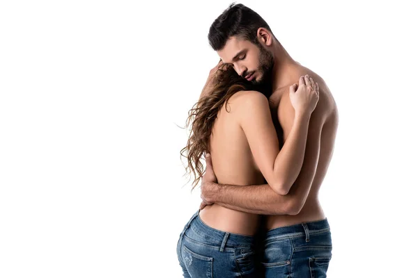 Beautiful sensual half naked couple hugging in jeans isolated on white — Stock Photo