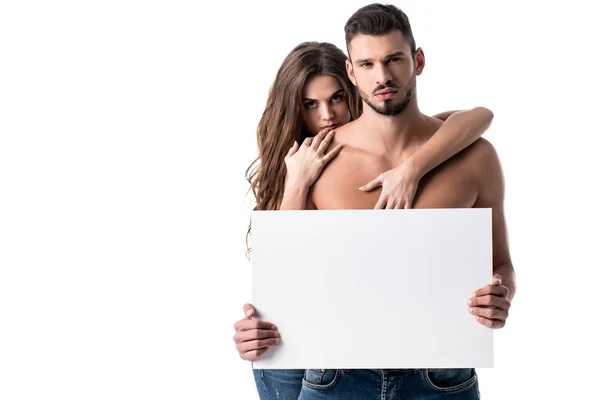 Young sensual couple in jeans with blank board isolated on white — Stock Photo