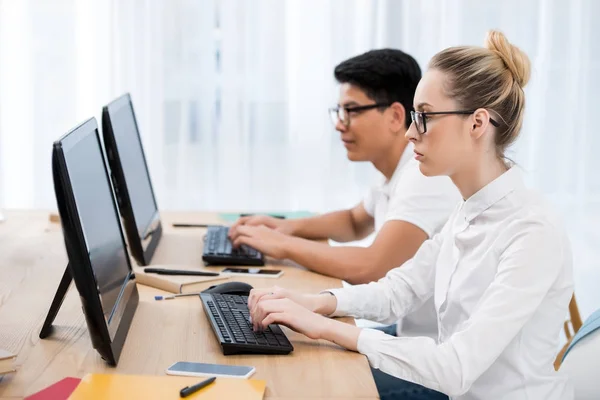 Jovens estudantes adolescentes trabalhando em computadores — Fotografia de Stock