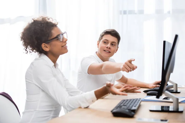 Young teenager students pointing on screen of computer — Stock Photo