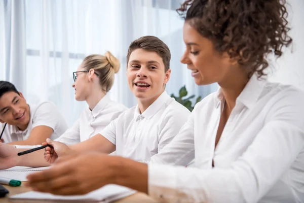 Young multicultural teenagers studying together — Stock Photo