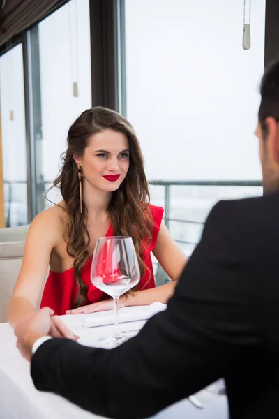 Partial view of couple holding hands on romantic date in restaurant on st valentine day — Stock Photo