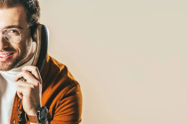 Partial view of smiling man talking on telephone isolated on beige — Stock Photo